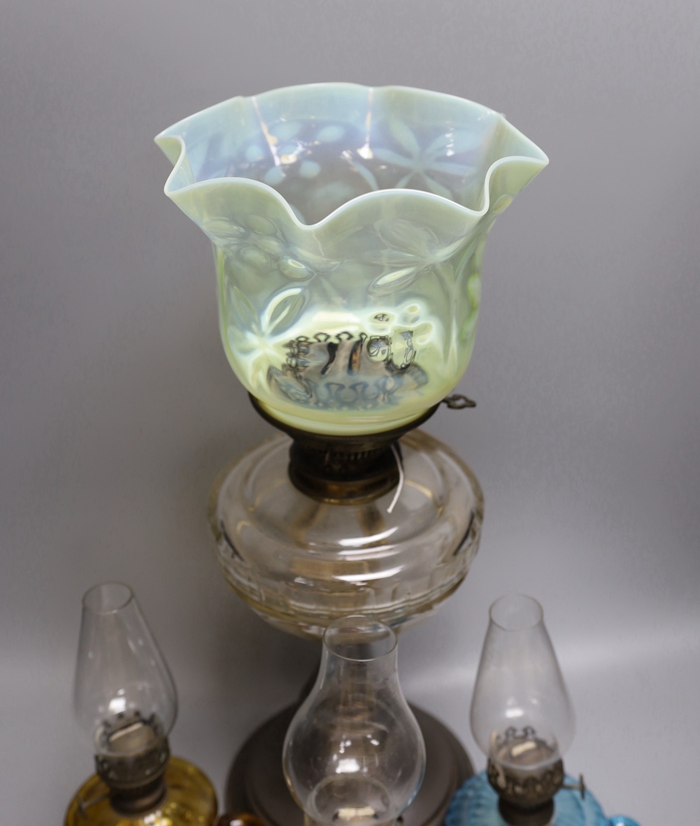 A Victorian oil lamp with vaseline glass shade and three small oil lamps, large oil lamp 49 cms high